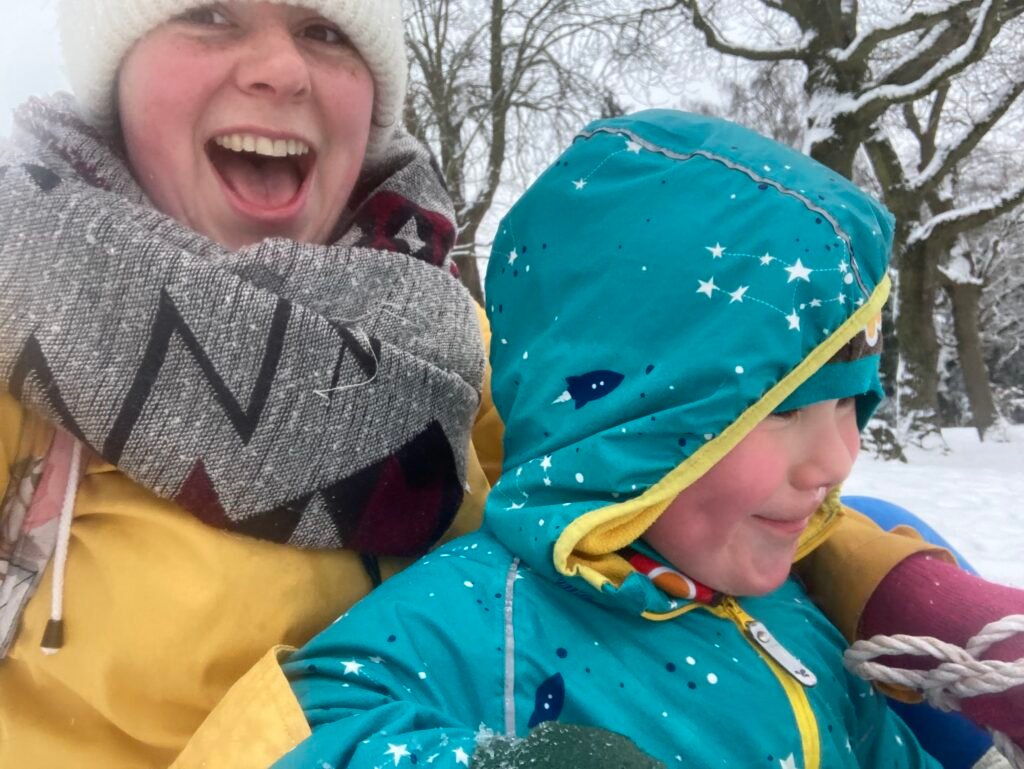 IMG_1691 photo of author with child on a sledge in snow
